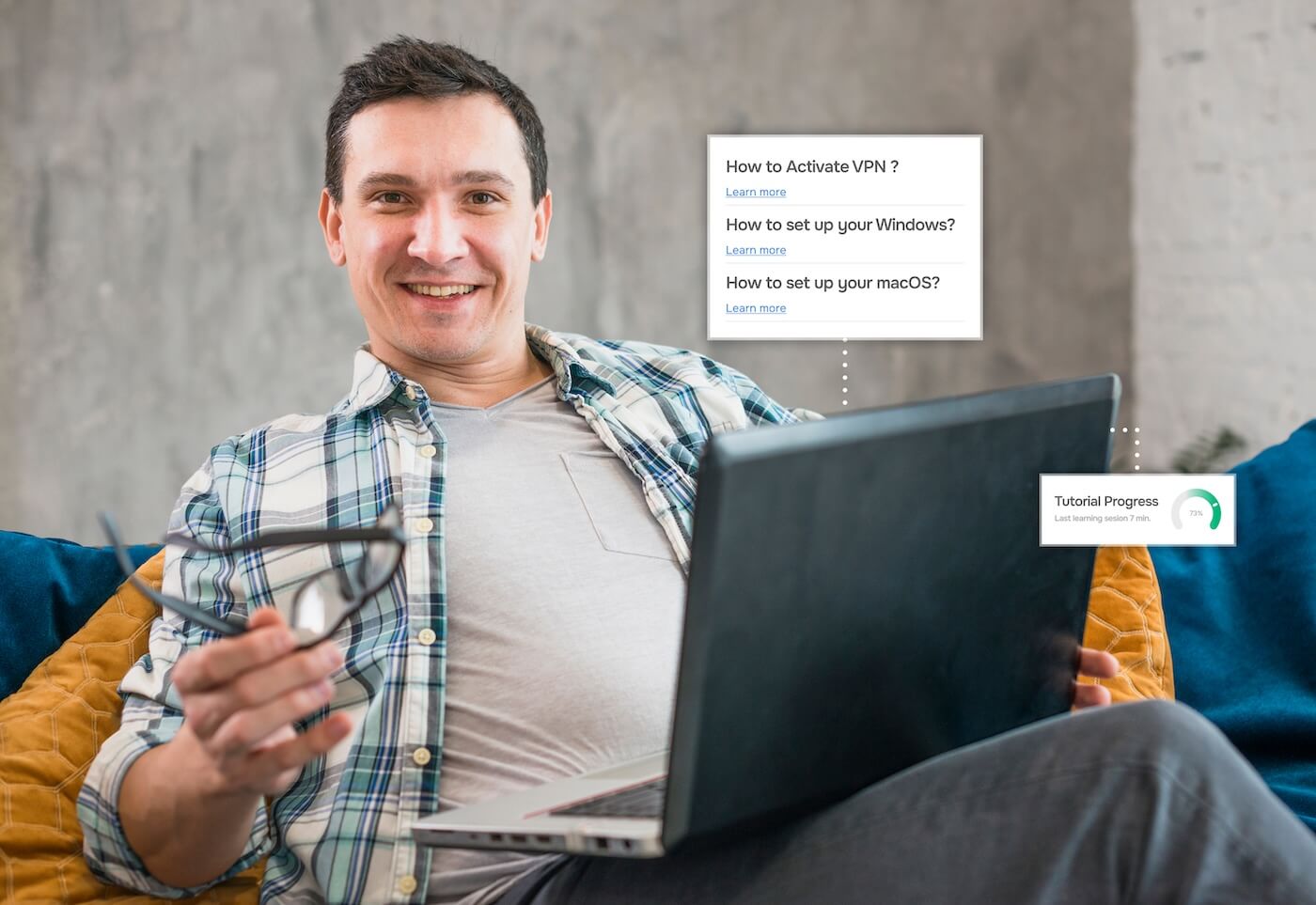 A man is sitting on a couch with a laptop on his lap. He is looking at the camera and smiling, holding his glasses in his right hand. There is a box floating in the air with the following questions, each followed by a “Learn More” link: “How to set up your desktop?”, “How to set up your Windows?”, and “How to set up your macOS?”.